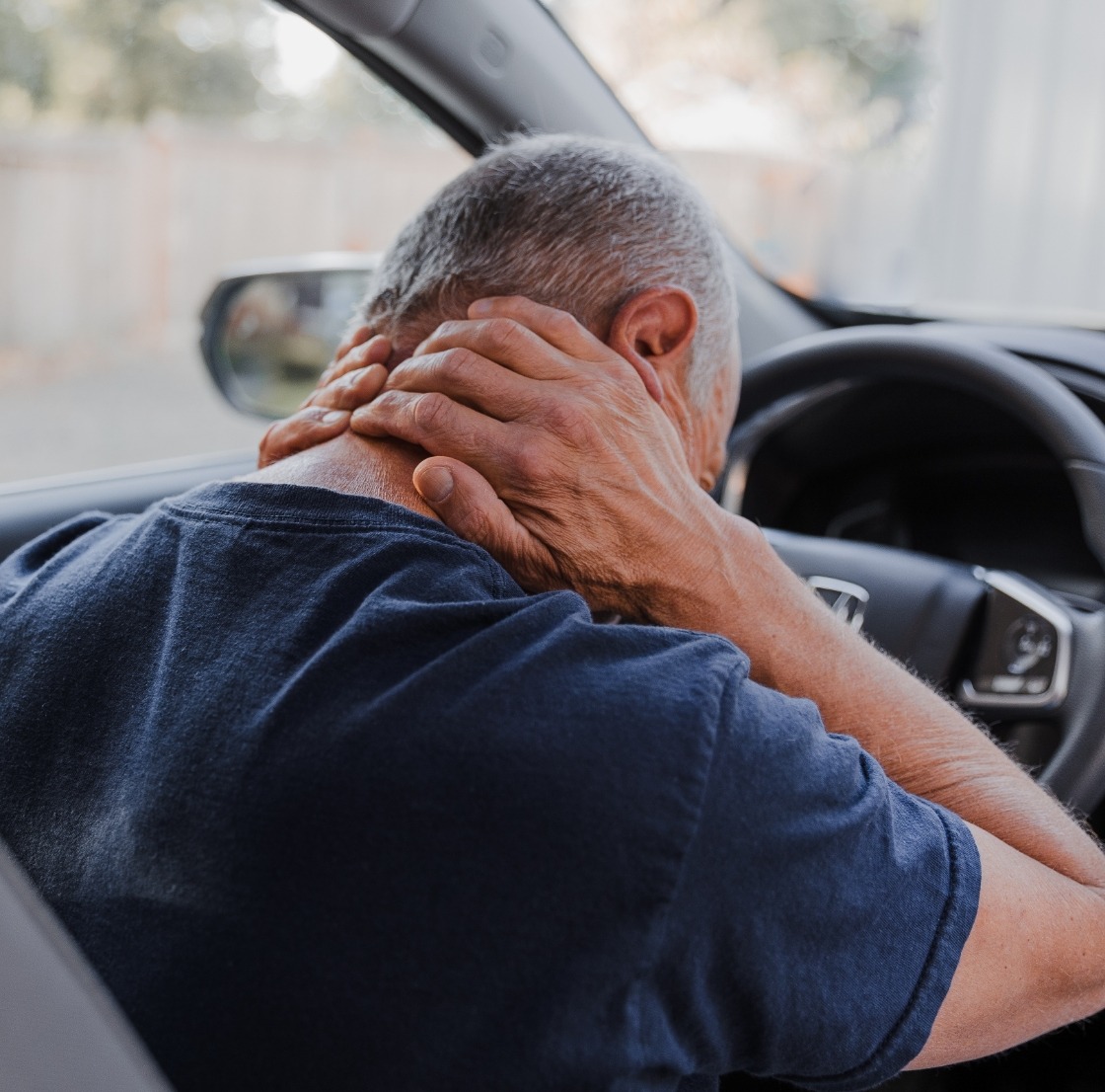 Man holding his neck and suffering a personal injury through car accident in Davie, Florida